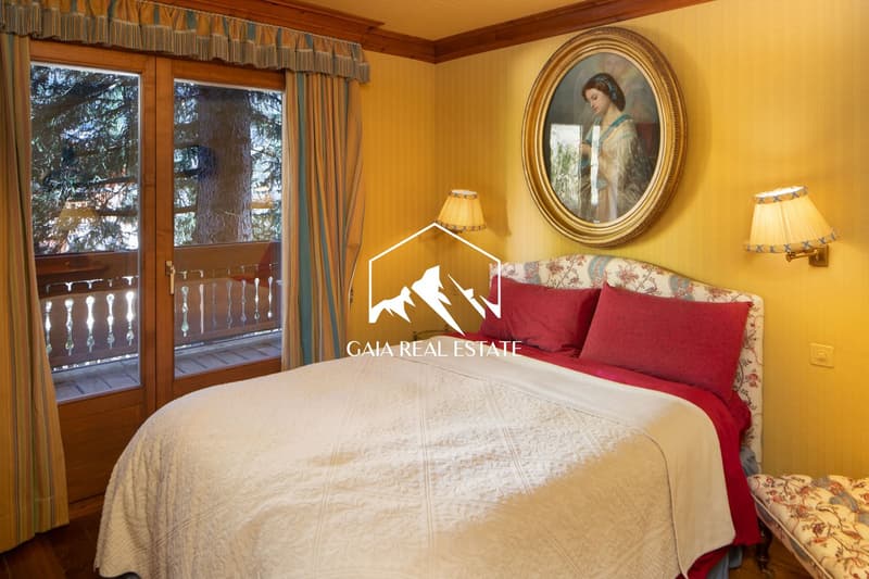 large bed, wooden railing balcony, picture frame, sliding doors, lamps