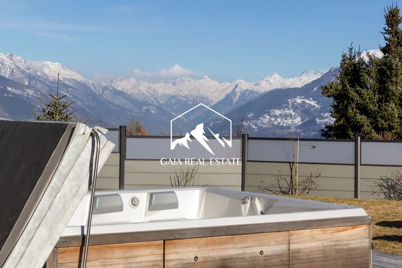 hot tub, wooden deck, fence, snow-capped mountains, pine trees
