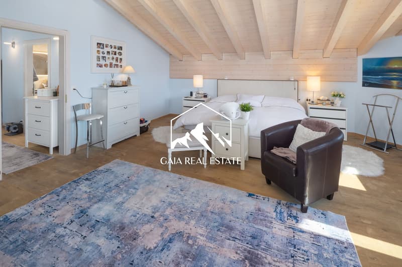 bedroom with bed, nightstands, lamps, chair, rug, wardrobe, mirror, picture frame, artwork