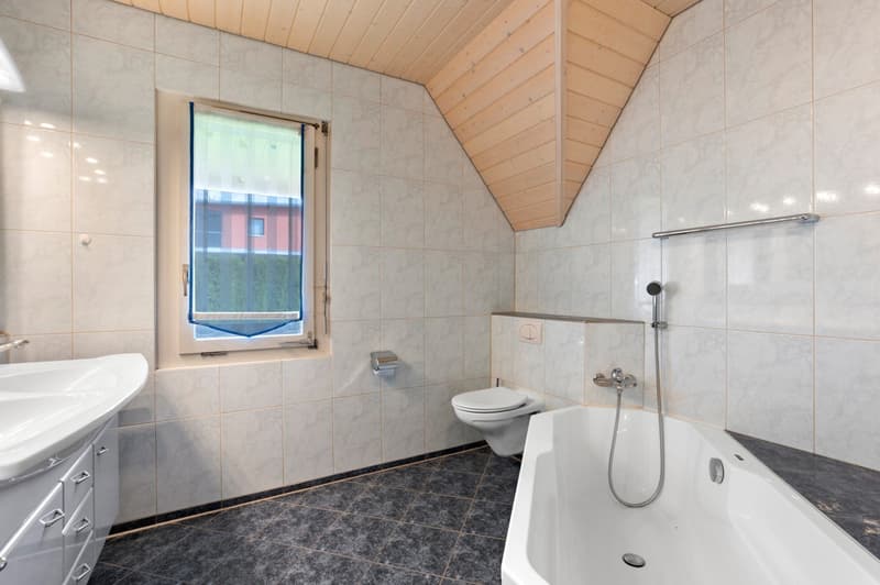Bathroom with bathtub, toilet, sink, wooden ceiling