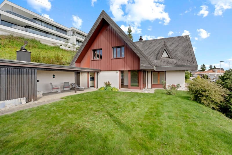 2 story house, red panels, red roof, beige basement, grassy lawn, outdoor chairs, modern design