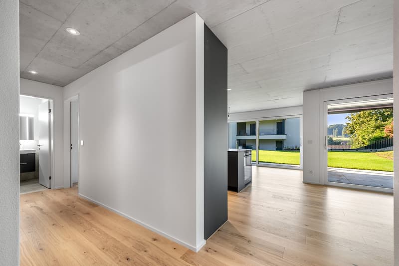 empty room, hardwood floor, white walls, open glass doors to an outdoor area