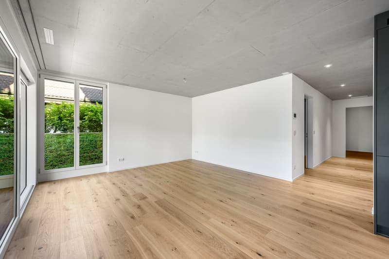 large windows, sliding glass door to balcony, hardwood floors, white walls