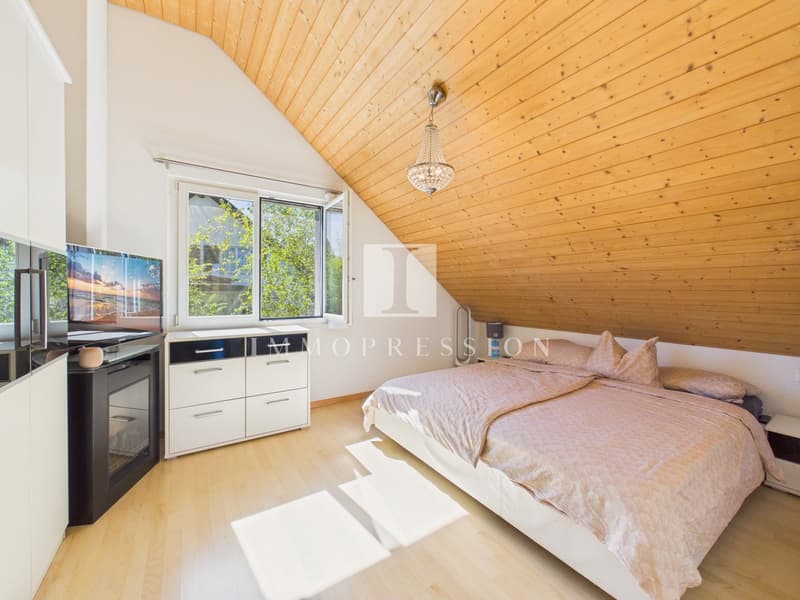 wooden ceiling, white walls, wooden floor, bed, TV, cabinet, fireplace
