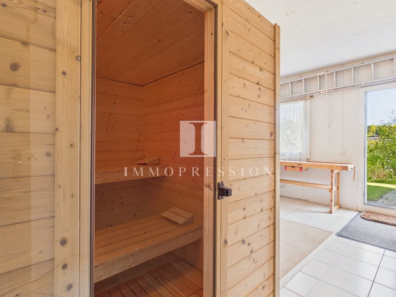 wooden sauna, wooden benches, glass door, wooden walls, wooden table, white tiles, rug