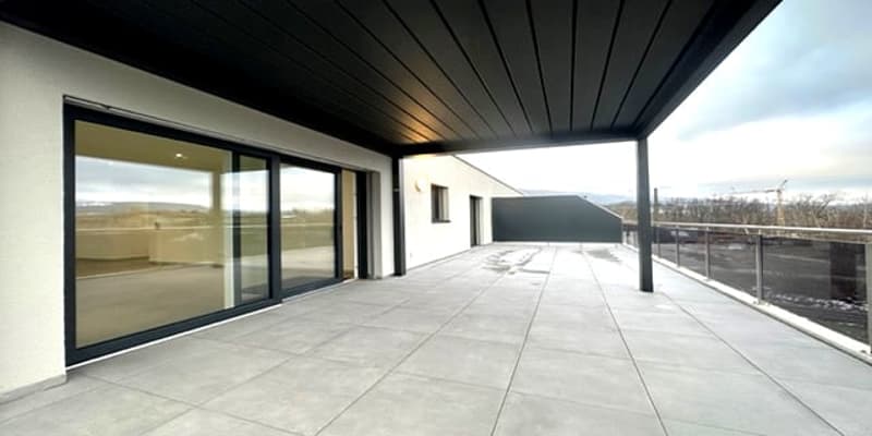 Empty balcony with sliding windows and a railing