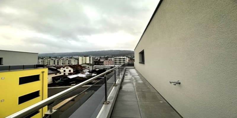 Metal railing, concrete floor, view of the city