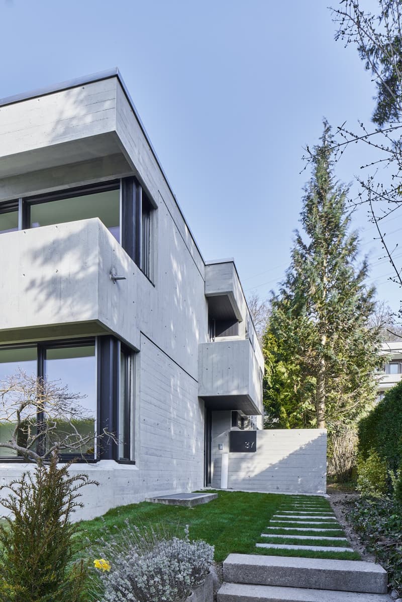 modern concrete house, large windows, balcony, concrete steps, garden