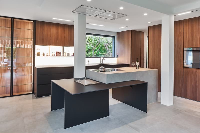 modern kitchen with island, wooden cabinets, granite countertops, large window, wine glasses, wine bottle, sink, faucet, wine rack, wine glasses, wine bottle