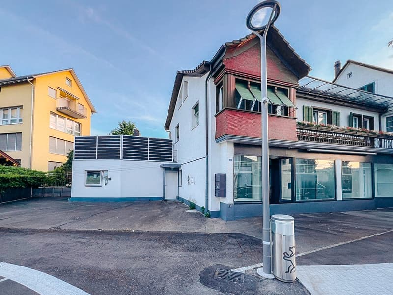 3 story house, red roof, white and red walls, solar panels, balcony, parking place