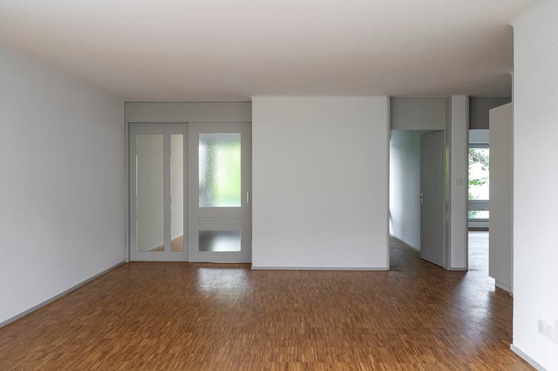 empty room, wooden floor, white walls, glass doors, power outlets