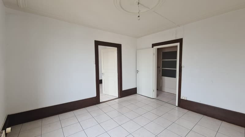 empty room, white walls, white tiles, wooden frame doors, ceiling lamp, wall outlet