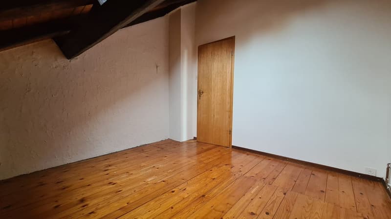 hardwood floor, white walls, wooden door, empty room