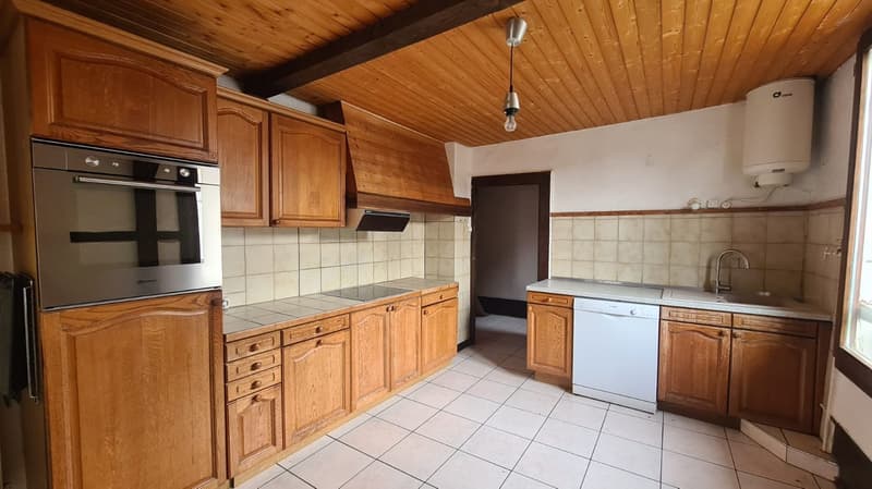 wooden cabinets, stainless steel oven, gas stove, wooden ceiling, white tiles, dishwasher