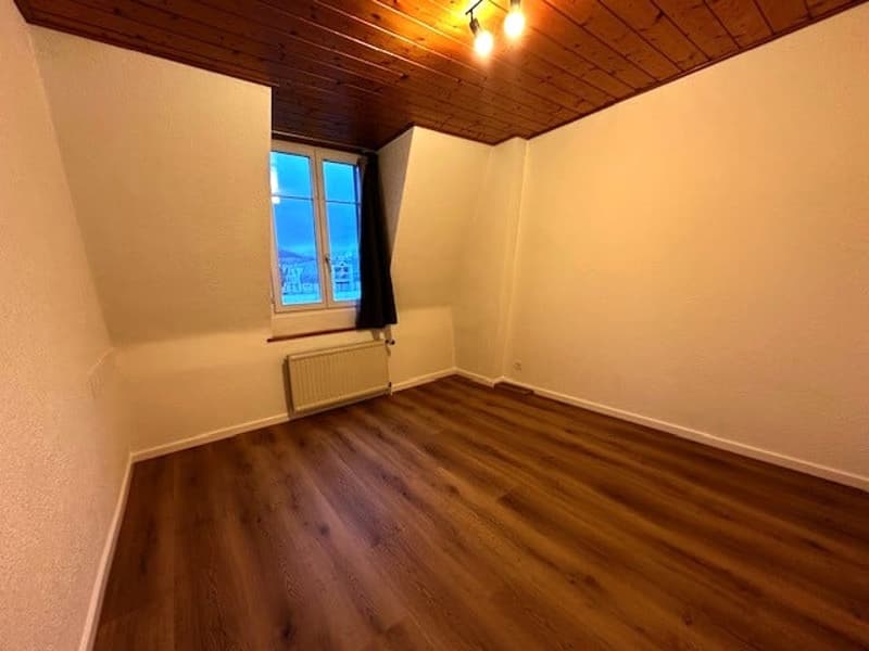 wood floor, white walls, window, black curtain, heater