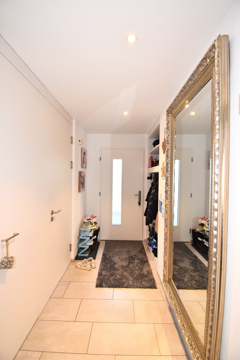 white walls, tiled floor, large mirror, shoe rack, white doors, ceiling lights
