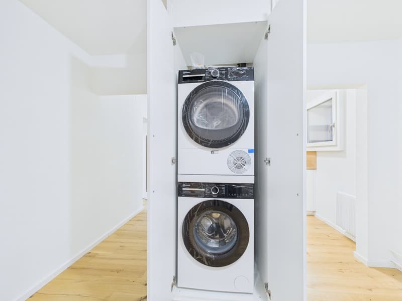 a white washing machine and a white dishwasher stacked together