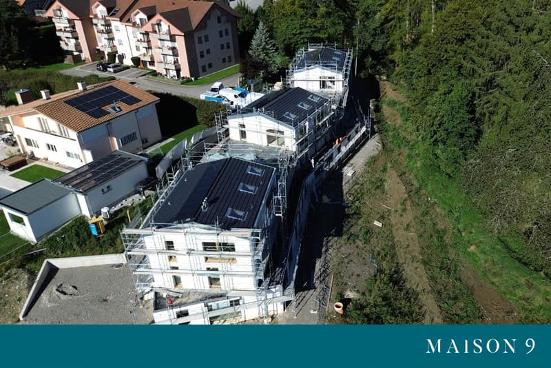 Houses under construction, solar panels, multiple levels, modern architecture, trees and plants surrounding