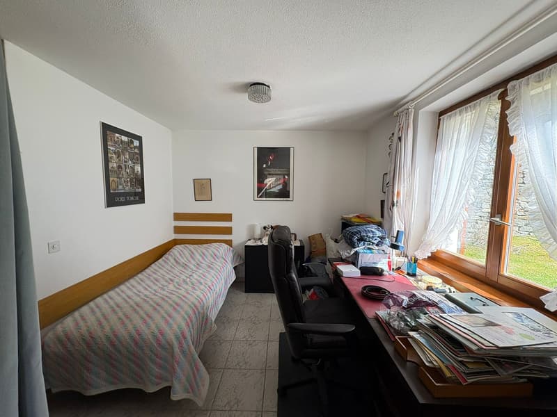 single bed, desk, chair, window with curtains, picture frames, tiled floor