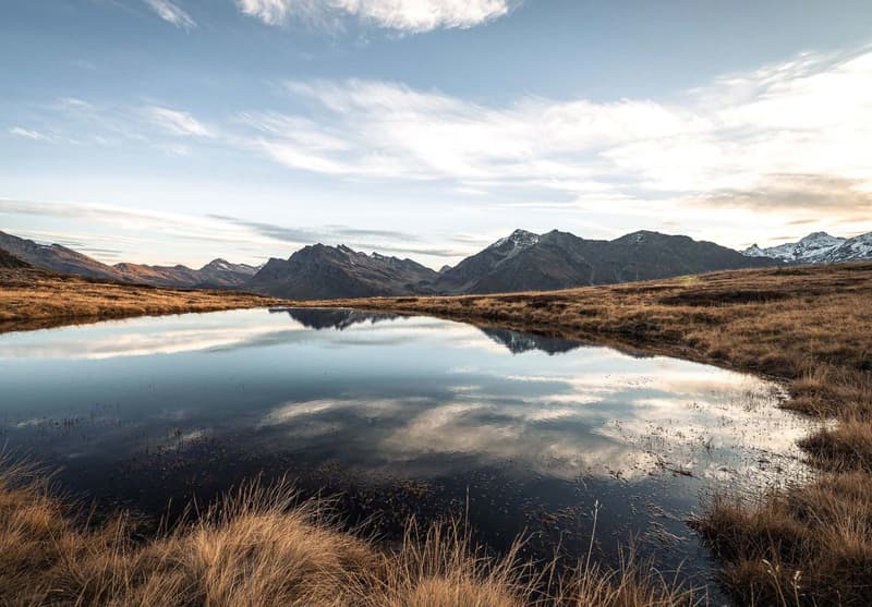 grassy field, lake, mountains, clouds