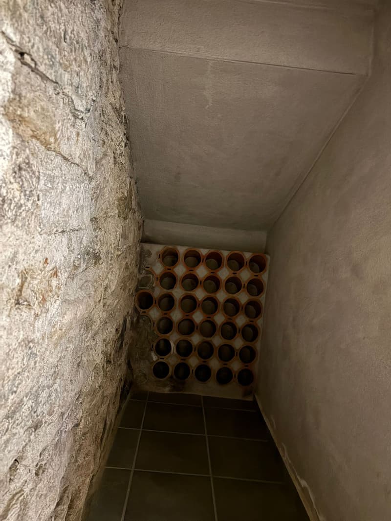 stone wall, tiled floor, wine rack