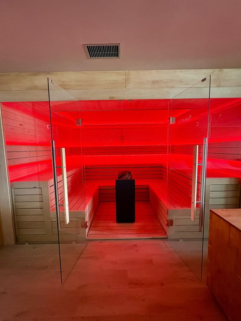 sauna with wooden benches and a red light