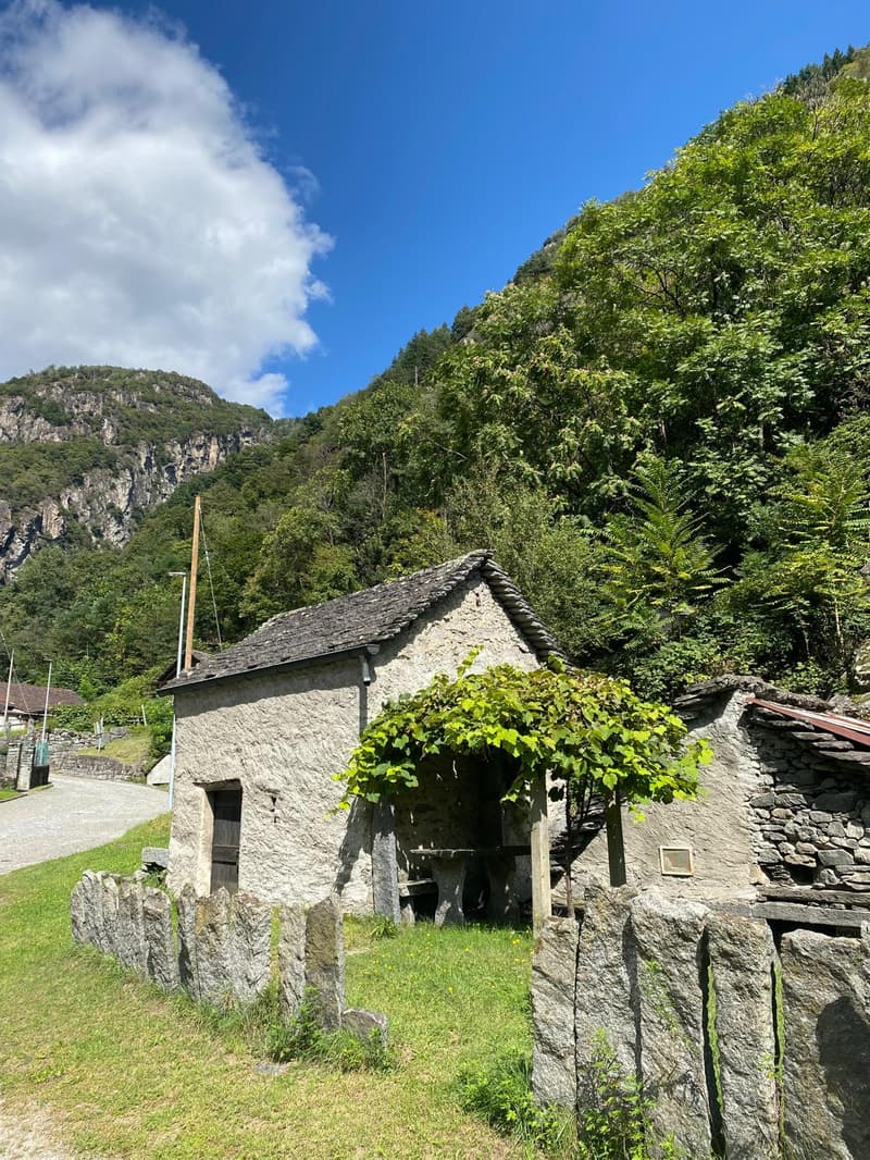 Old stone house, stone roof, wooden door, stone wall, mountain view