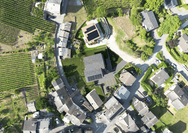 Solar panels on roof, garden, swimming pool, multiple houses in the area