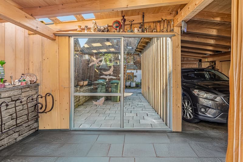 wooden walls, glass door, car parked inside, stone wall, wooden beams