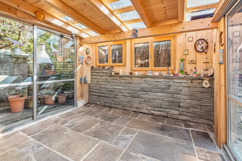 wooden ceiling, glass walls, stone floor, stone wall, skylights, outdoor plants