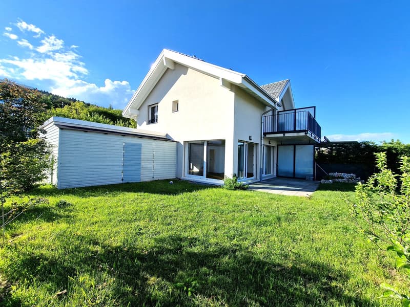 Modern white house, 2 stories, balcony, garage, large windows, green lawn