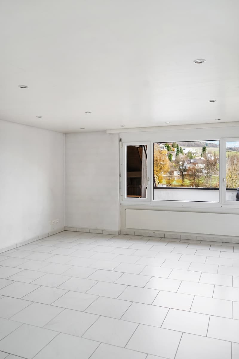 White walls, white floor tiles, two white power outlets, double window with balcony