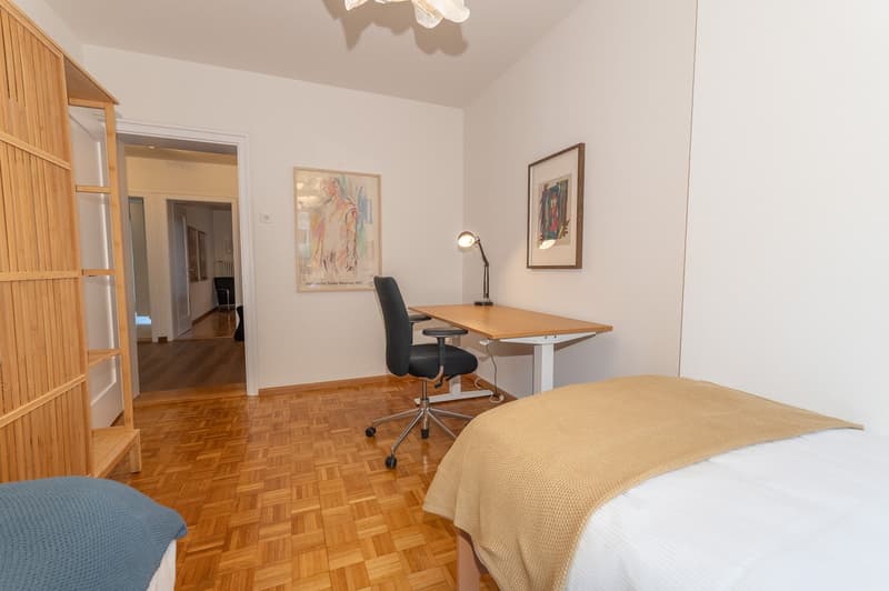 Wooden bed, desk, chair, wooden shelves, wooden floors, paintings, lamps