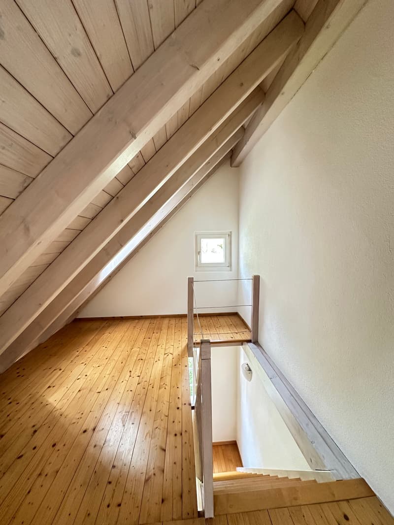 wooden floor, wooden beams, white walls, small window, wooden staircase