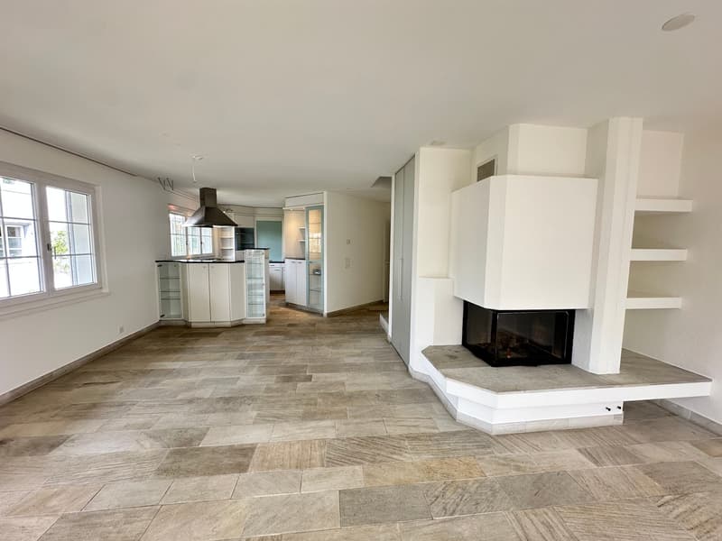 Open floor plan, fireplace, kitchen, dining area, large windows