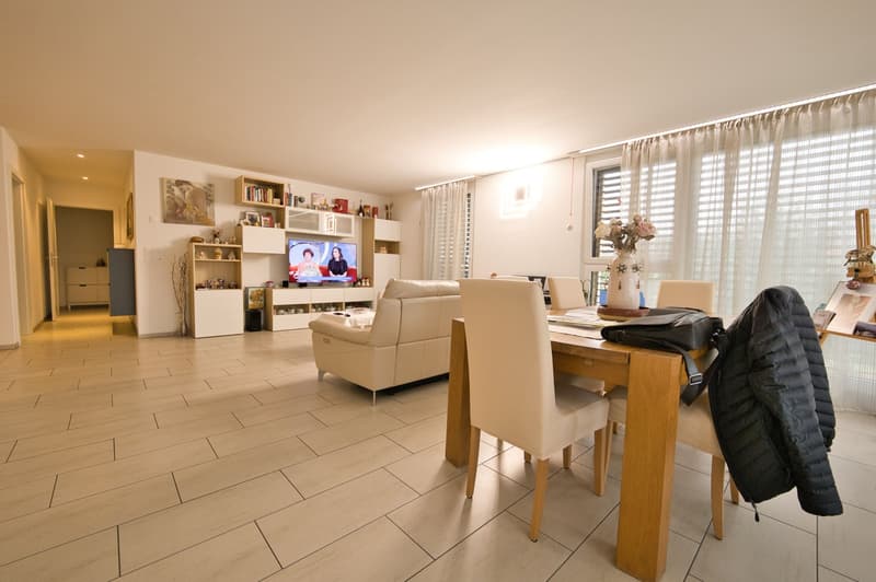 white leather sofa, dining table, tv in wall mounted cabinet, wooden floor, dining chairs