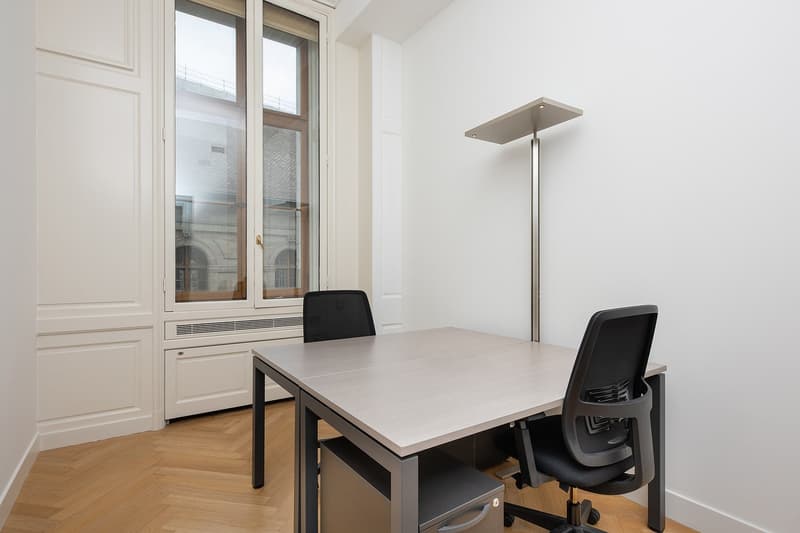 Modern interior with wooden floor, desk, chairs, floor lamp, window with view outside