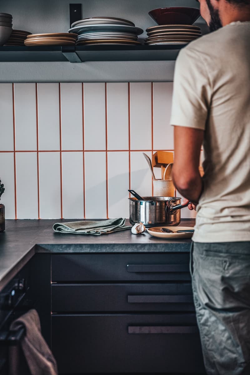 kitchen, counter, pots, pans, plates, bowls, utensils, spices