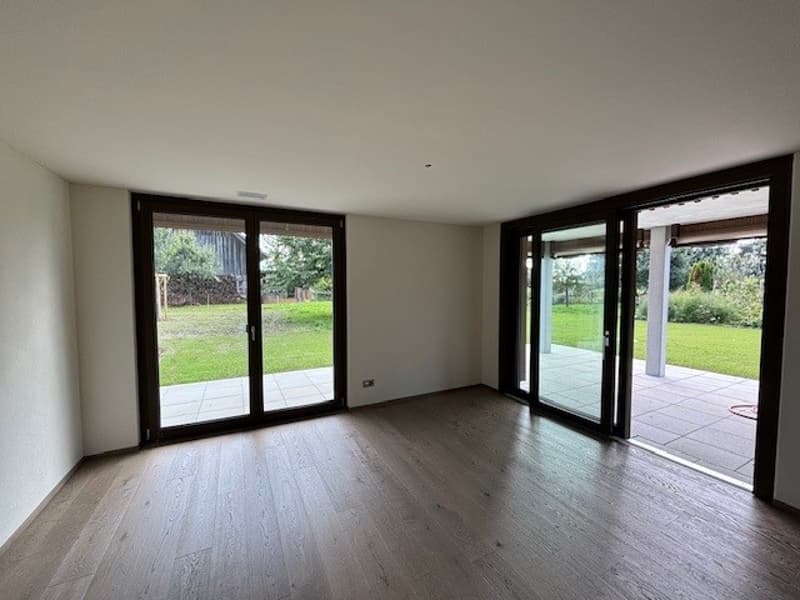 empty room, wooden floor, sliding glass doors, balcony, view of the garden