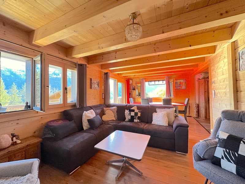 L-shaped sofa, wooden coffee table, chandelier, floor to ceiling windows, wooden wall