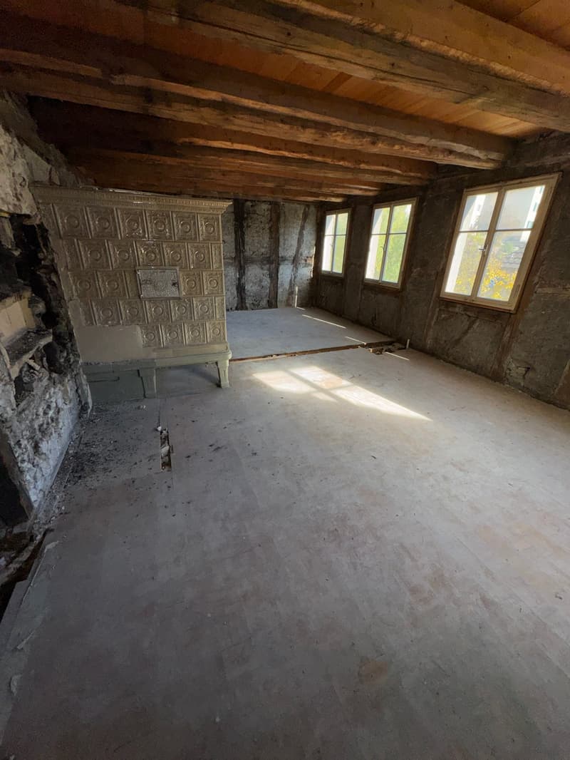 empty room with wooden ceiling, fireplace, concrete floor, 3 windows