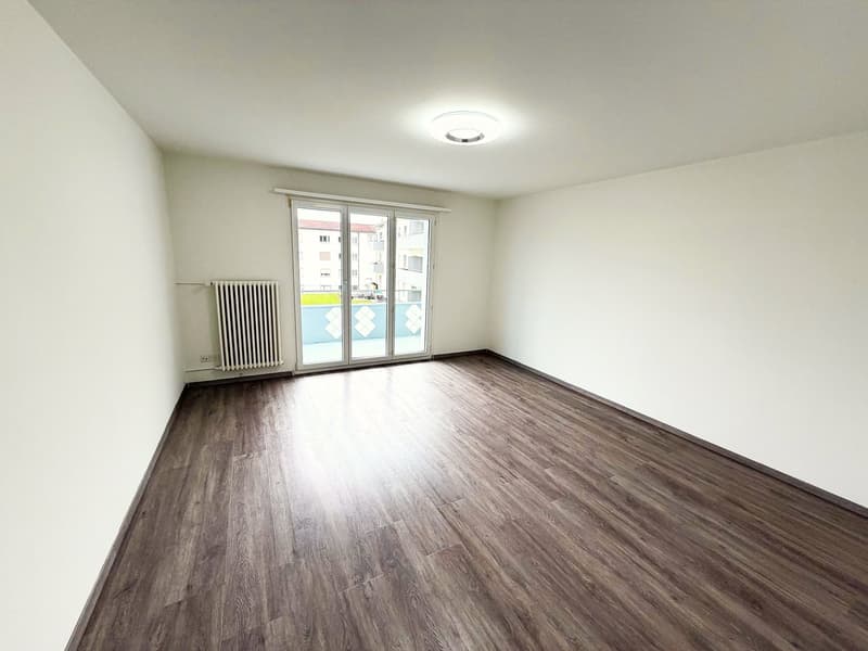 empty room, white walls, wooden floor, sliding glass door, balcony, radiator