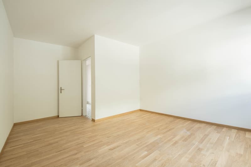 empty room, white walls, wooden floor, open door