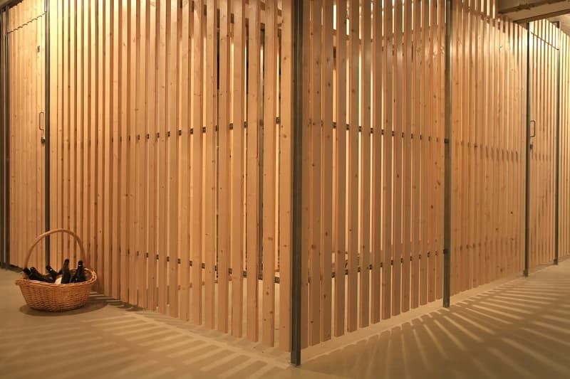 Wooden storage room with a basket filled with bottles