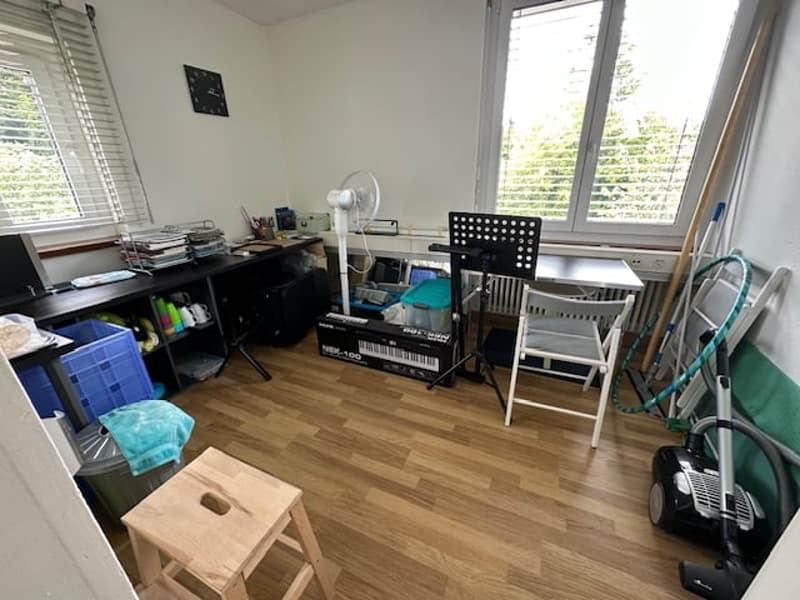 office room, wooden floor, desk, monitor, shelves, stool, piano, fan, cleaning equipment