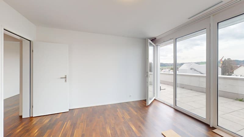 wooden floor, white walls, large sliding doors to balcony
