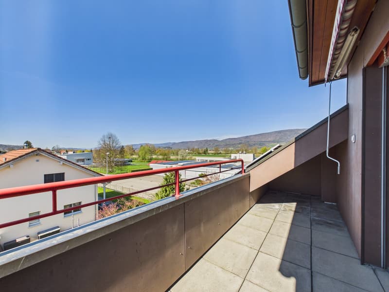Balcony with red railing, tiled floor, view of the surroundings