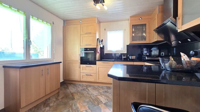 kitchen with appliances, cabinets, countertops, and tiled flooring
