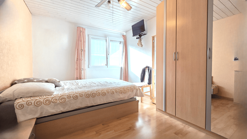 bed, wardrobe, window, bedsheet with patterns, mounted television