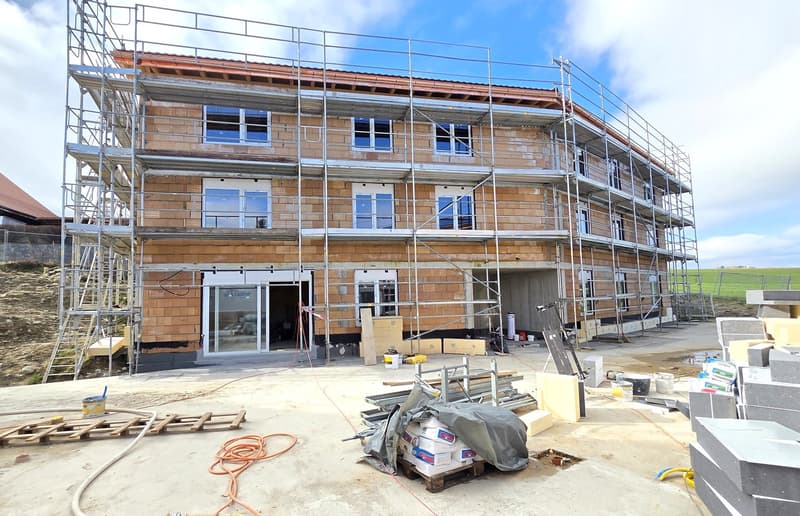 under construction, brick wall, glass windows, metal scaffolding, open doors, construction materials